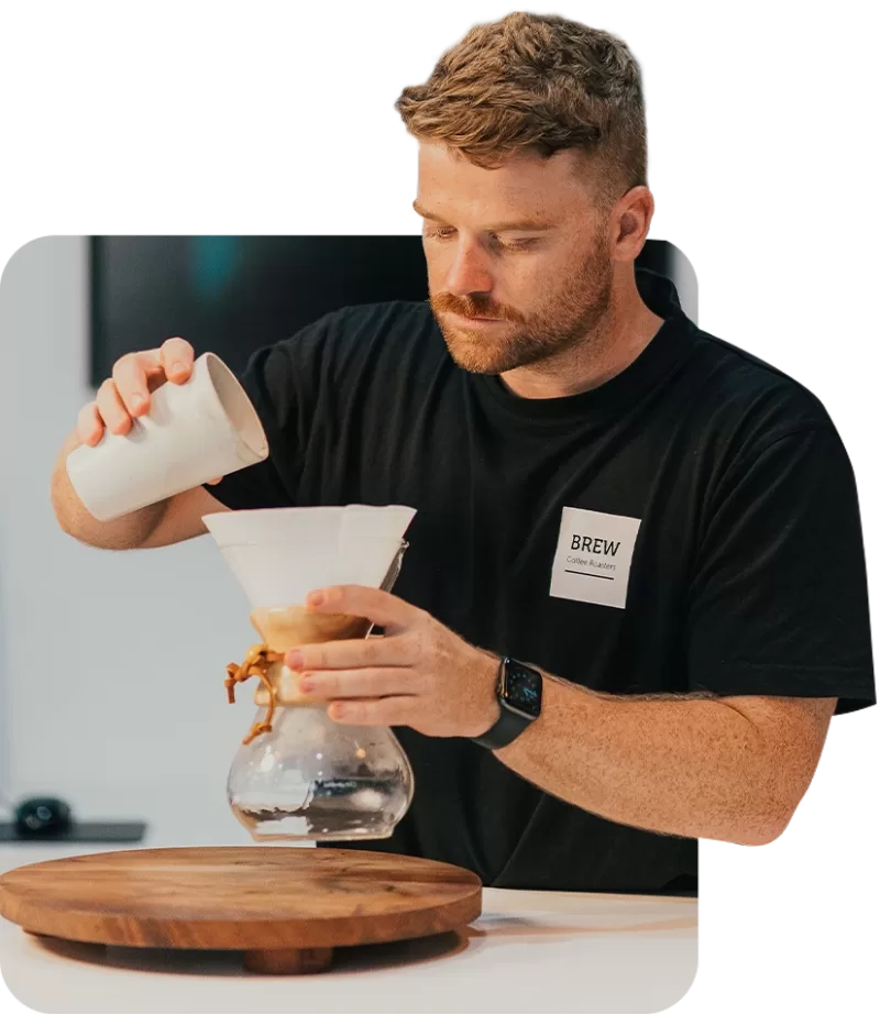A barista pouring coffee at Brew Coffee Roasters Perth
